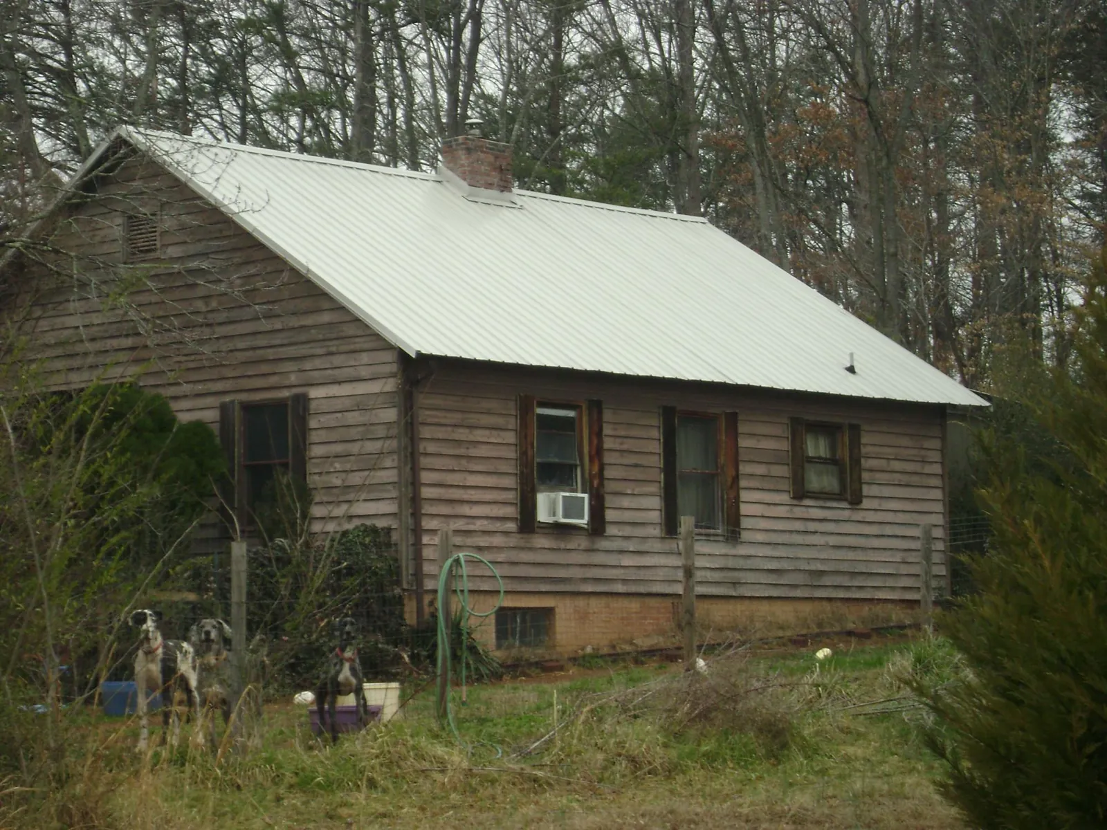 White metal roof on an old wood sided farmhouse, from a Metal Roof Installation job in Lovejoy